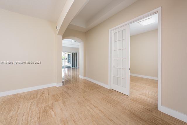1737 Harbor View Circle Weston, FL 33327 - Photo 7 of 15 an empty room with wooden floor and mirror