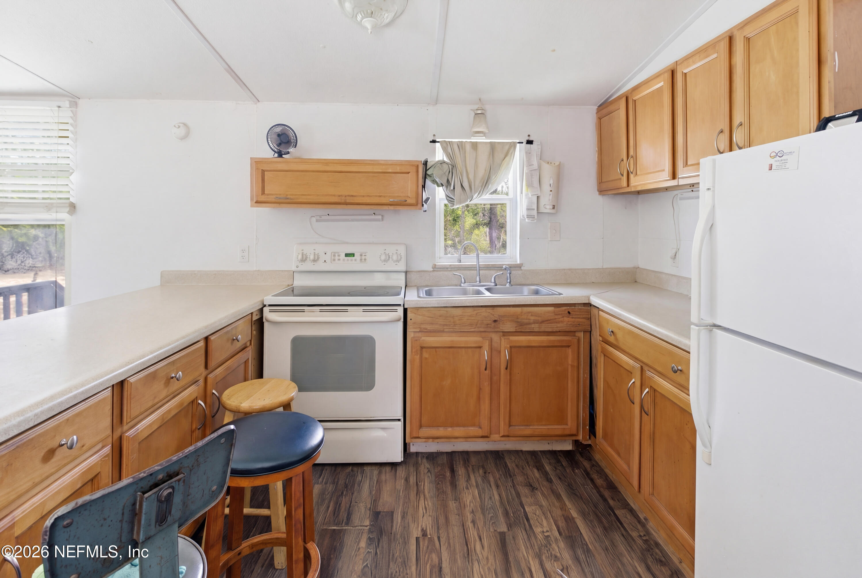 116 London Avenue Interlachen, FL 32148 - Photo 7 of 25 a kitchen with a stove a sink and a refrigerator