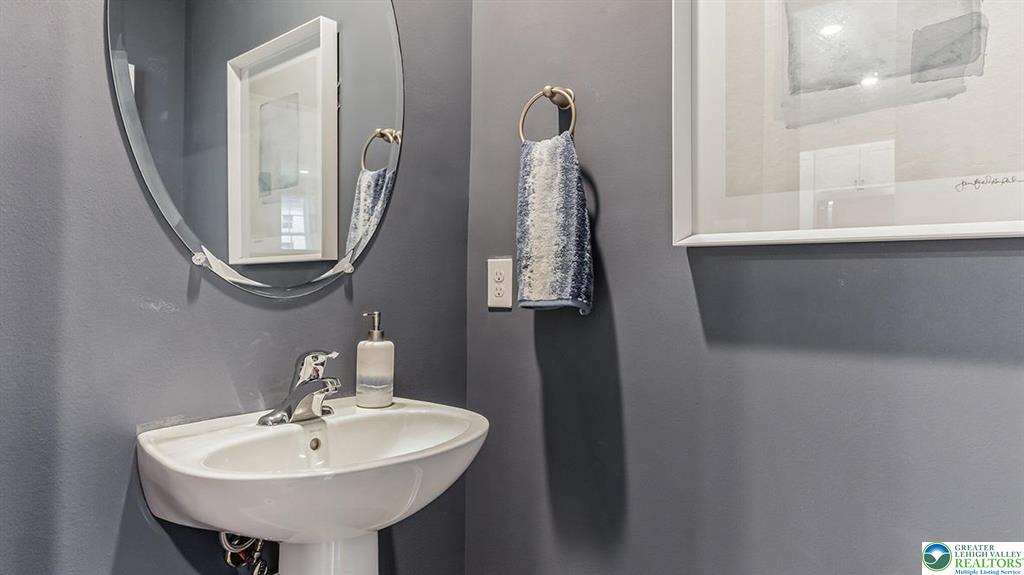 1145 Martin Road Breinigsville, PA 18031 - Photo 11 of 38 A well-appointed half-bath offers convenience and style with a sleek pedestal sink.
