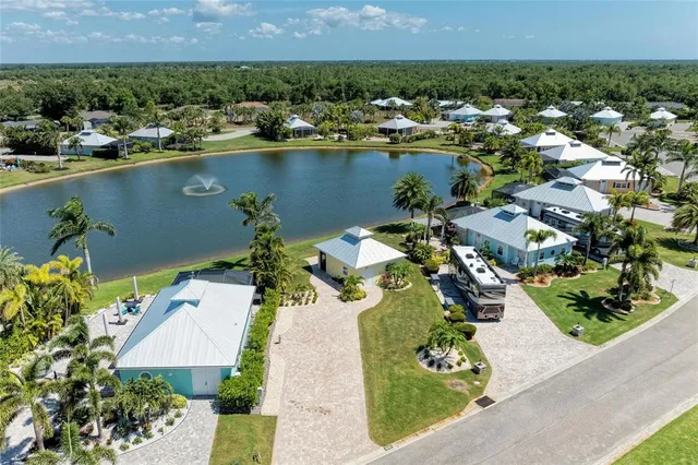 an aerial view of a house with a yard and lake view
