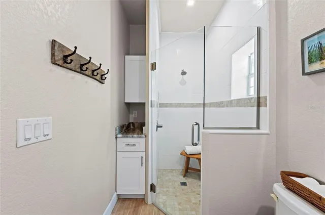 a bathroom with a toilet and a shower