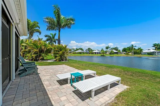 a view of a lake with couches and wooden floor