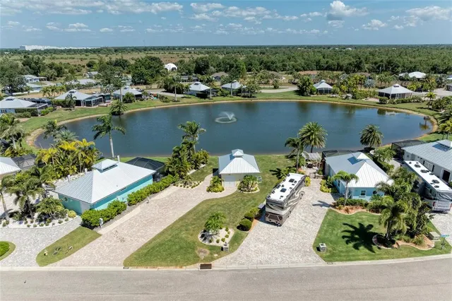 an aerial view of a house with a yard lake view and mountain view