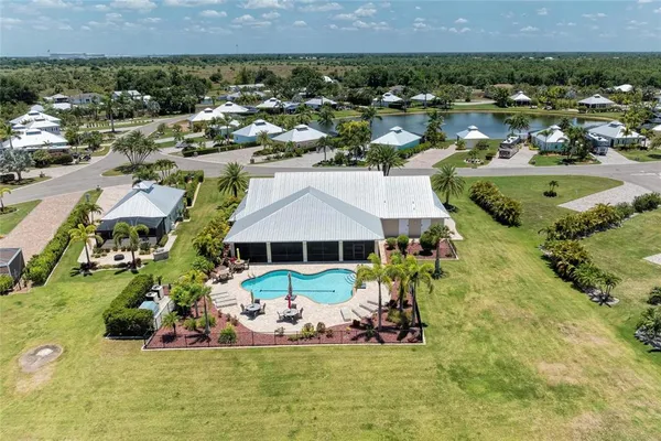 an aerial view of a house with a garden and lake view