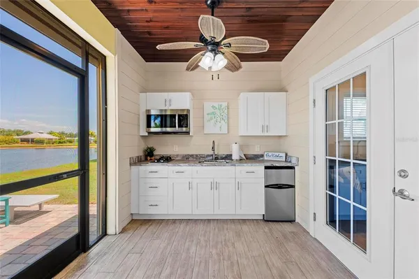 a kitchen with stainless steel appliances granite countertop a stove oven and a refrigerator with wooden floors