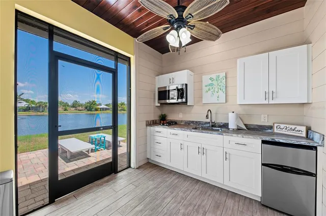 a kitchen with stainless steel appliances granite countertop a stove a sink and a granite countertops with wooden floor