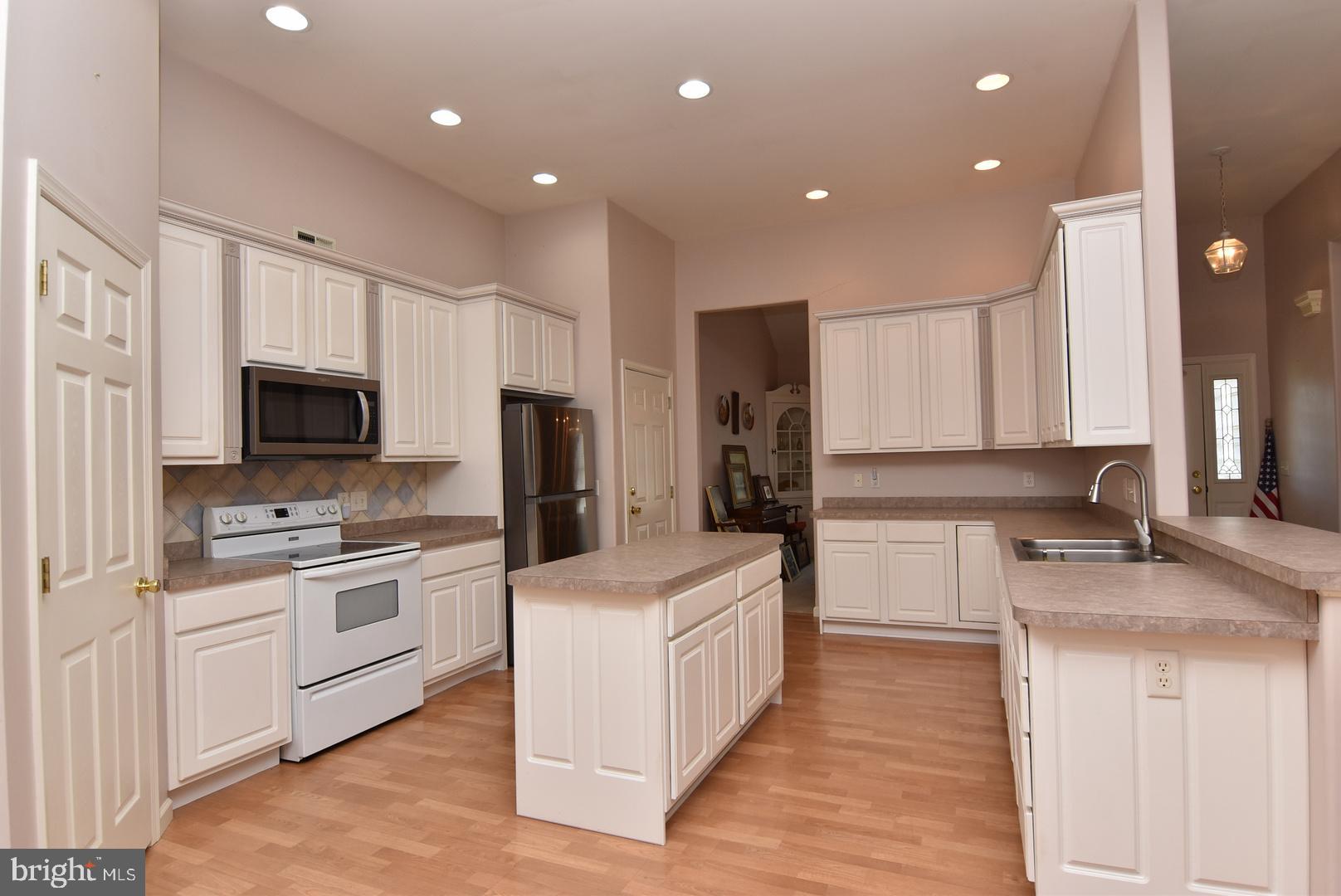 30849 Old Landing Road Laurel, DE 19956 - Photo 6 of 27 a large kitchen with stainless steel appliances kitchen island a cabinets and a counter top space