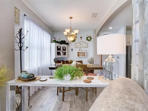 a view of a dining room with furniture and chandelier