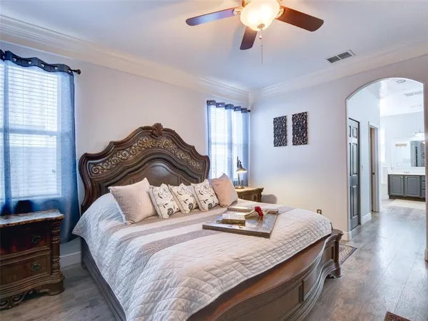 a bedroom with bed and a chandelier