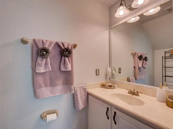 a bathroom with a sink vanity and mirror