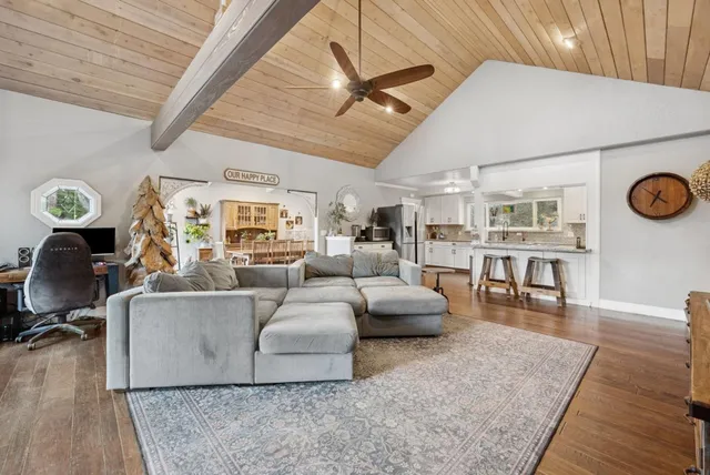 a dining room with furniture and a flat screen tv