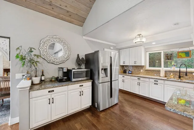 a spacious bedroom with a bed a couch and a large window