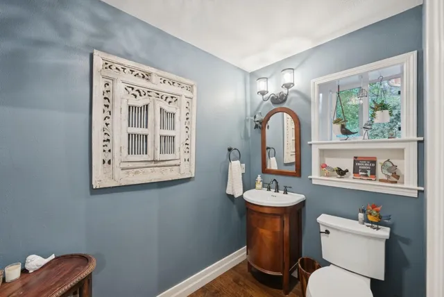 a bathroom with a sink a mirror and a toilet