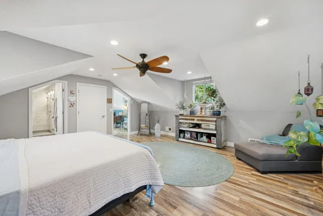 a spacious bathroom with a sink a toilet a mirror and shower