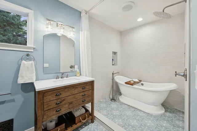 a view of a patio with couches chairs under an umbrella