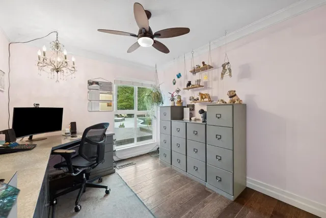 a view of a house with a yard and large trees