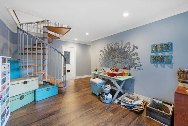 a view of a backyard with a table and chairs and iron fence