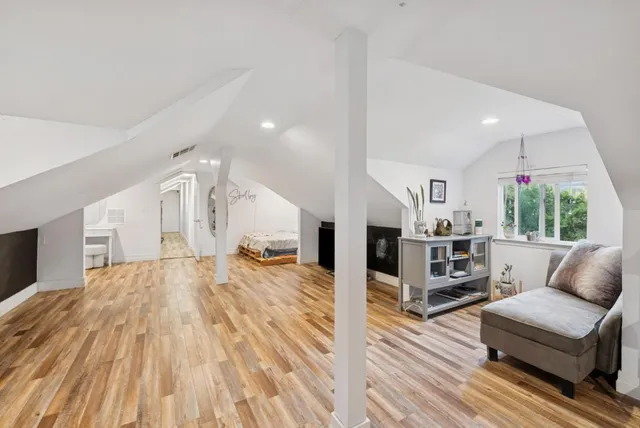 an aerial view of a house with a yard and lake view