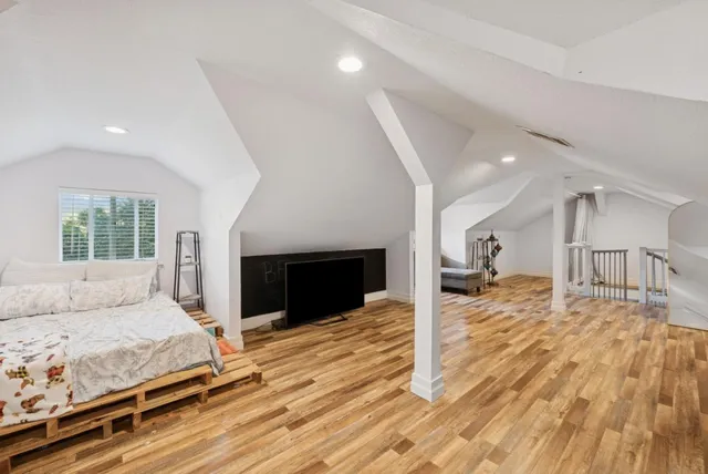 an aerial view of residential houses with outdoor space and trees