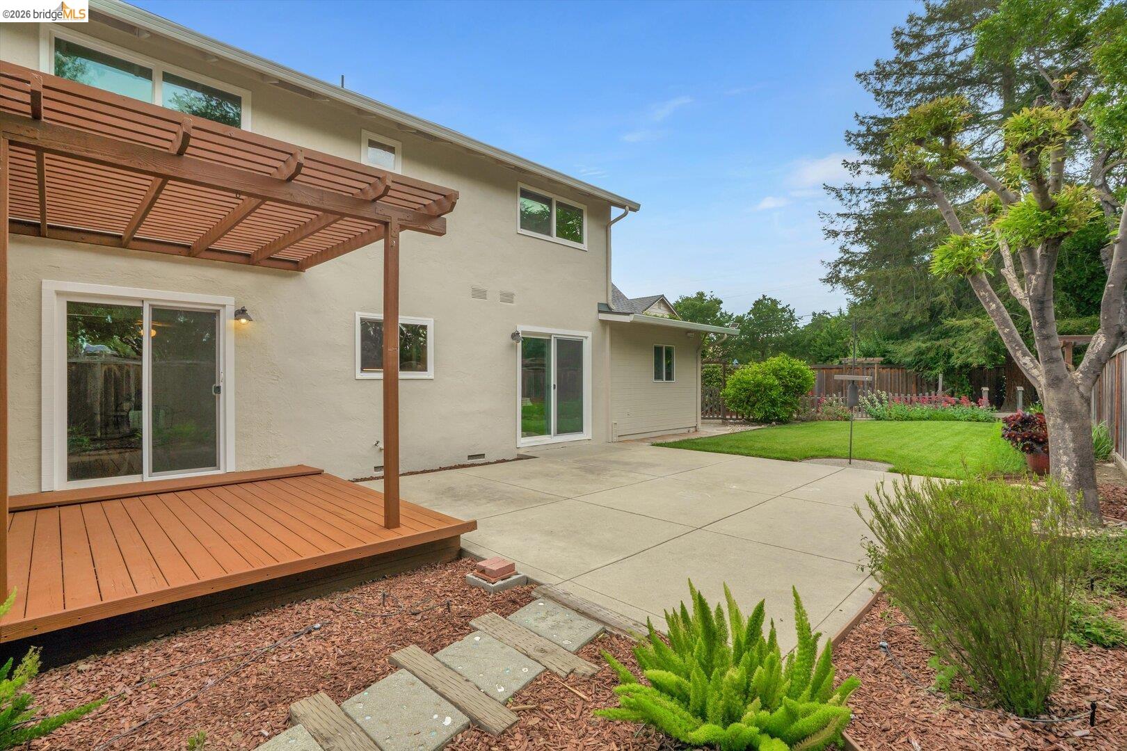 1878 Polk Street Concord, CA 94521 - Photo 32 of 40 a backyard of a house with table and chairs under an umbrella