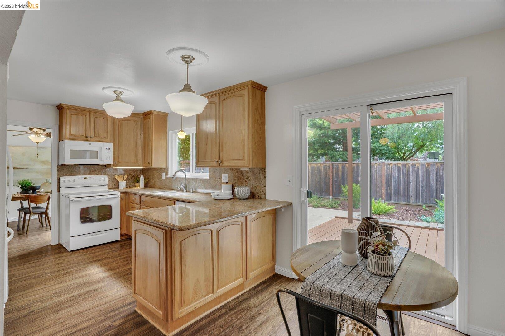 1878 Polk Street Concord, CA 94521 - Photo 10 of 40 a kitchen with a table chairs stove and wooden floor