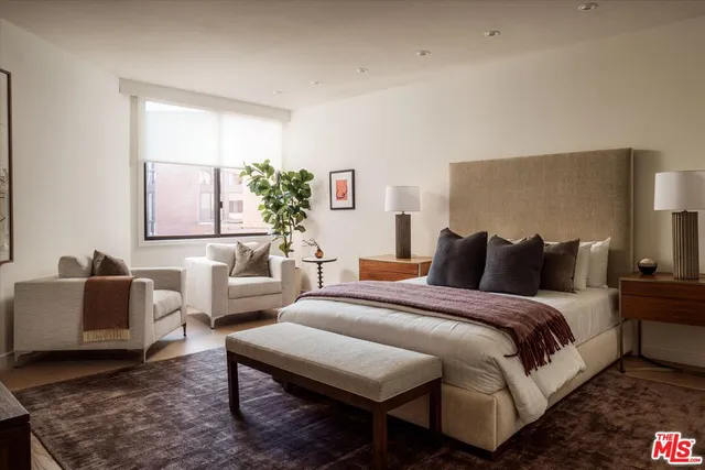 a spacious bedroom with a bed and a couch