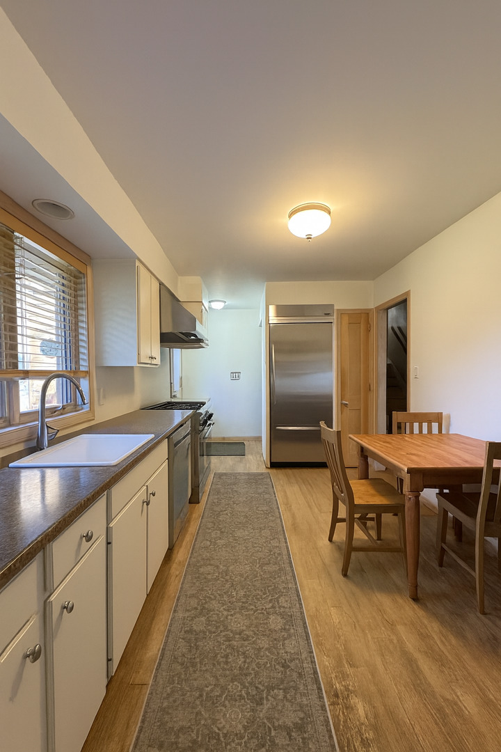 1024 Arbor Lane Glenview, IL 60025 - Photo 4 of 9 a large kitchen with a table and chairs in it