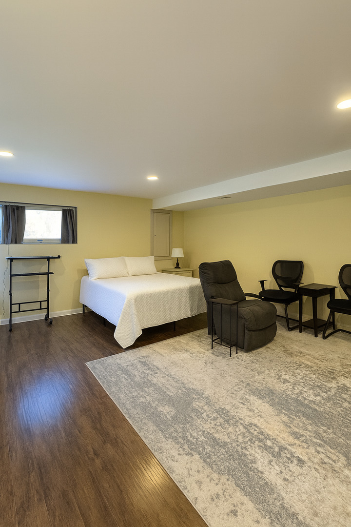 1024 Arbor Lane Glenview, IL 60025 - Photo 5 of 9 a spacious bedroom with a bed a table and a couch