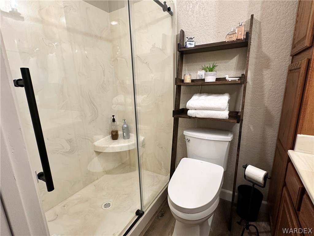 6615 Flag Mine Road Kingman, AZ 86401 - Photo 25 of 72 a bathroom with a toilet and a shower
