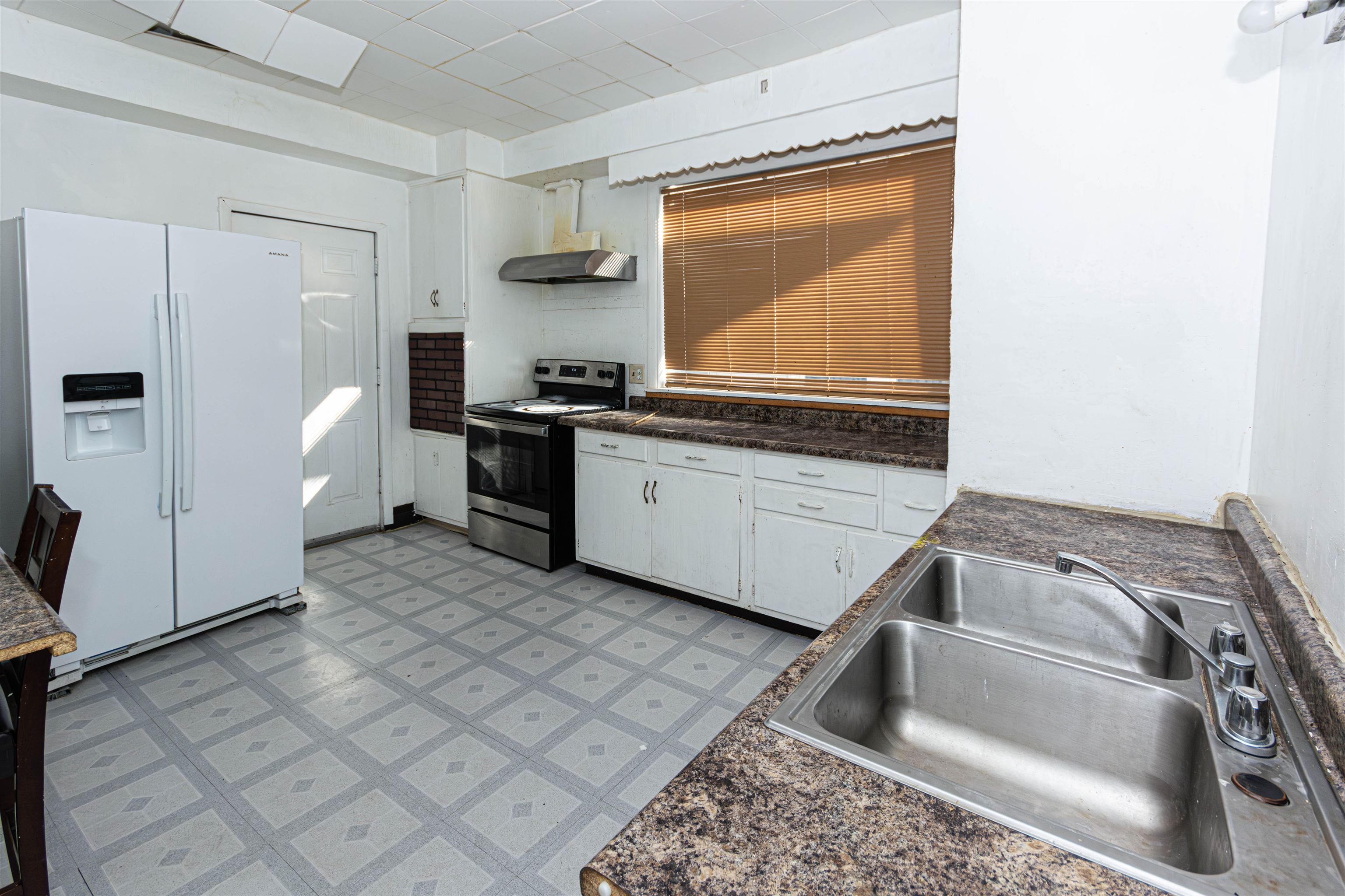 1017 Ridge Avenue Rockford, IL 61103 - Photo 16 of 20 a kitchen with stainless steel appliances granite countertop a sink and a refrigerator
