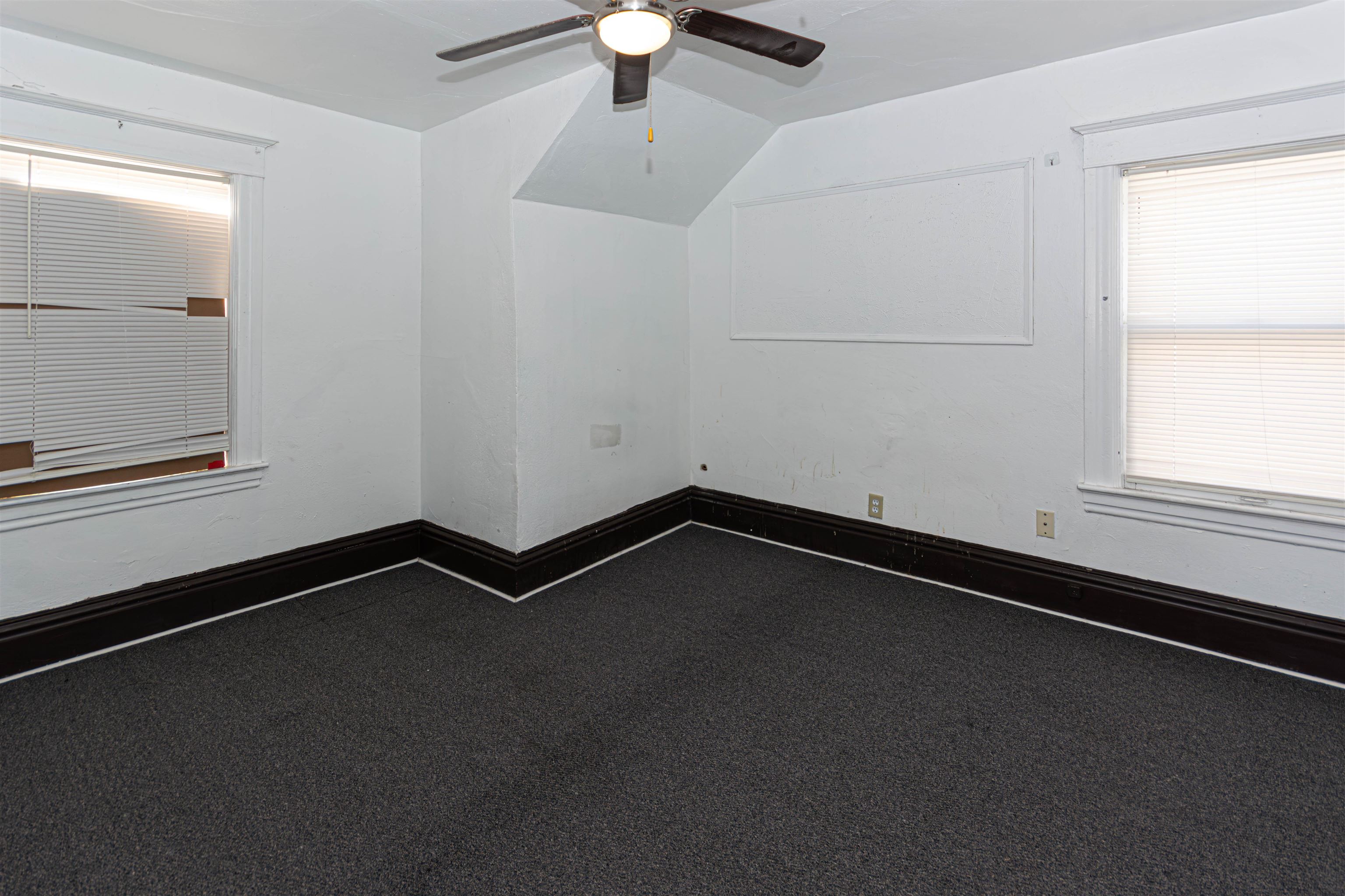1017 Ridge Avenue Rockford, IL 61103 - Photo 2 of 20 an empty room with a empty space and a ceiling fan