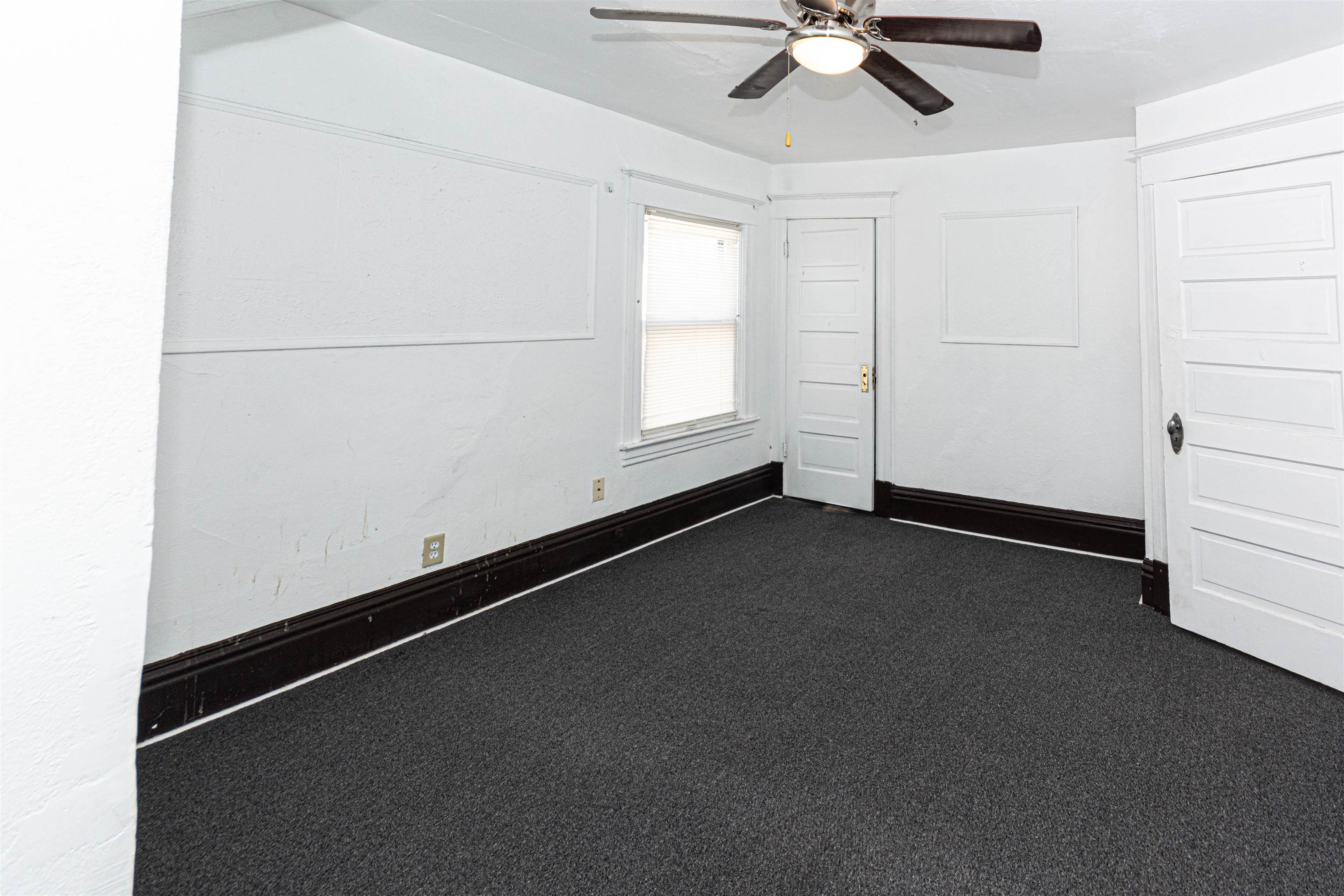 1017 Ridge Avenue Rockford, IL 61103 - Photo 9 of 20 an empty room with a ceiling fan and a window