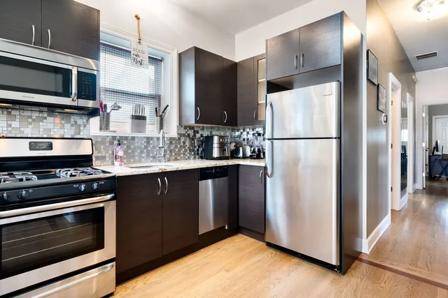 a kitchen with stainless steel appliances a refrigerator stove and microwave