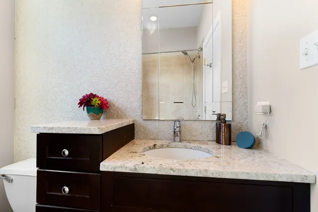 a bathroom with a sink vanity and granite