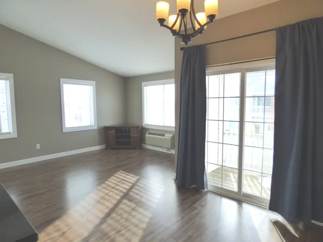 a view of entryway with wooden floor and chandelier