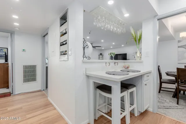 a kitchen with a sink and chairs