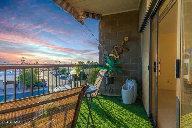 a view of a balcony with chair and the potted plant