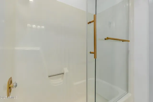 a view of walk in closet with clothes