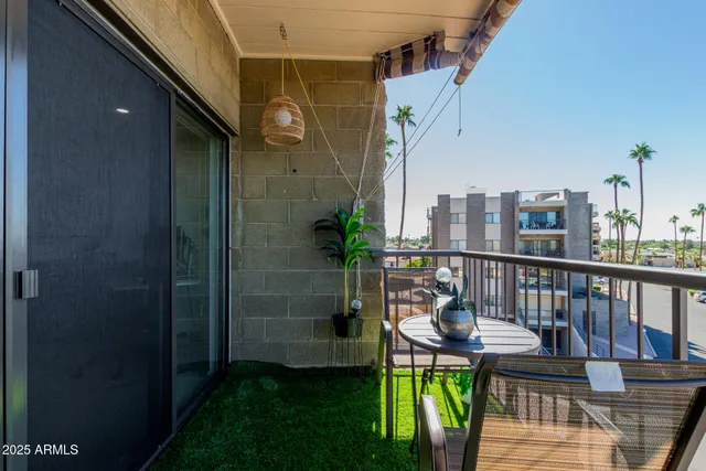 a view of a balcony with chairs and a table