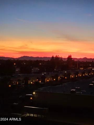 a sign board with buildings in the background
