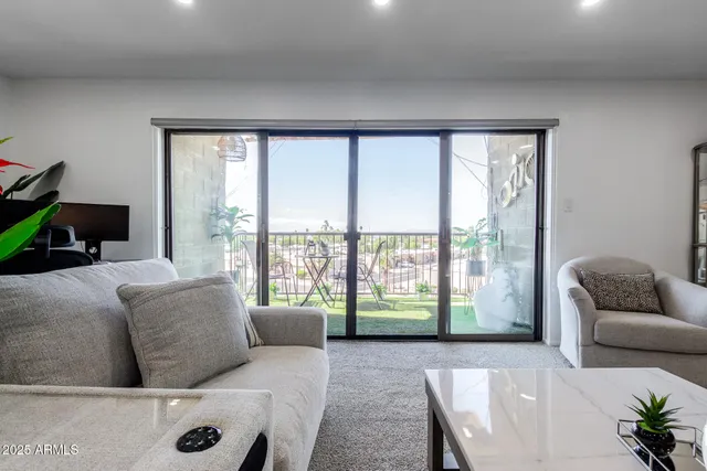 a living room with furniture and a floor to ceiling window