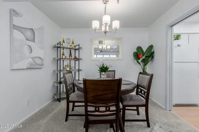 a view of a dining room with furniture and chandelier
