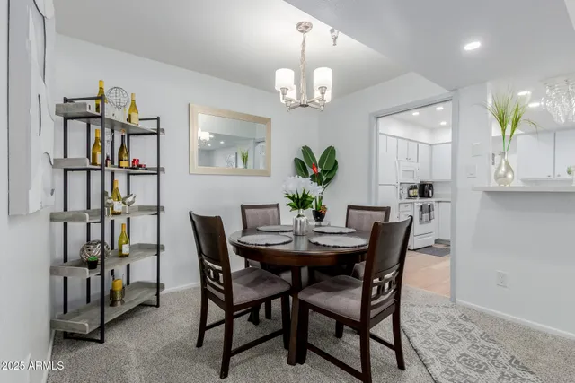 a view of a dining room with furniture and a chandelier