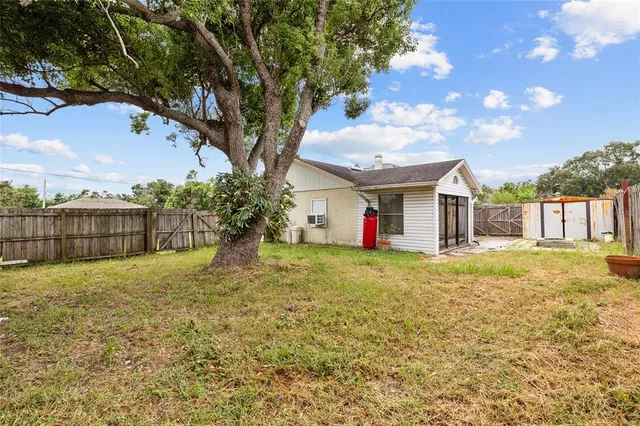 a backyard of a house with table and chairs
