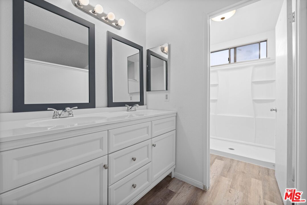1415 Kings Road Palmdale, CA 93551 - Photo 14 of 27 a bathroom with a double vanity sink and a mirror