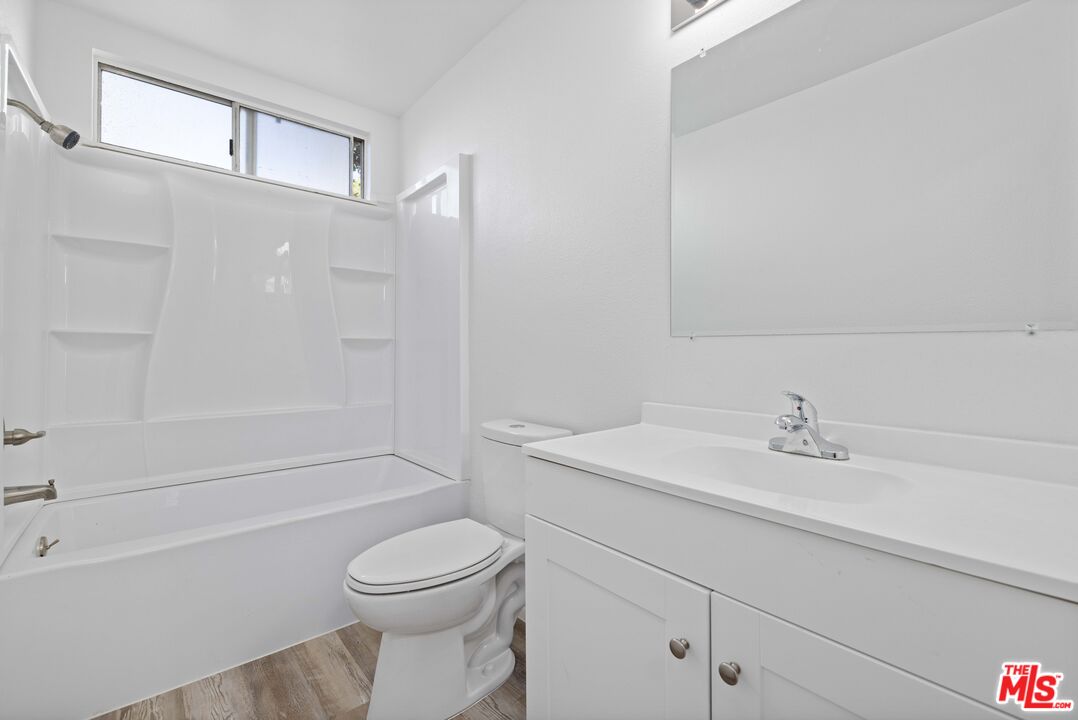 1415 Kings Road Palmdale, CA 93551 - Photo 17 of 27 a bathroom with a sink a toilet and a bathtub