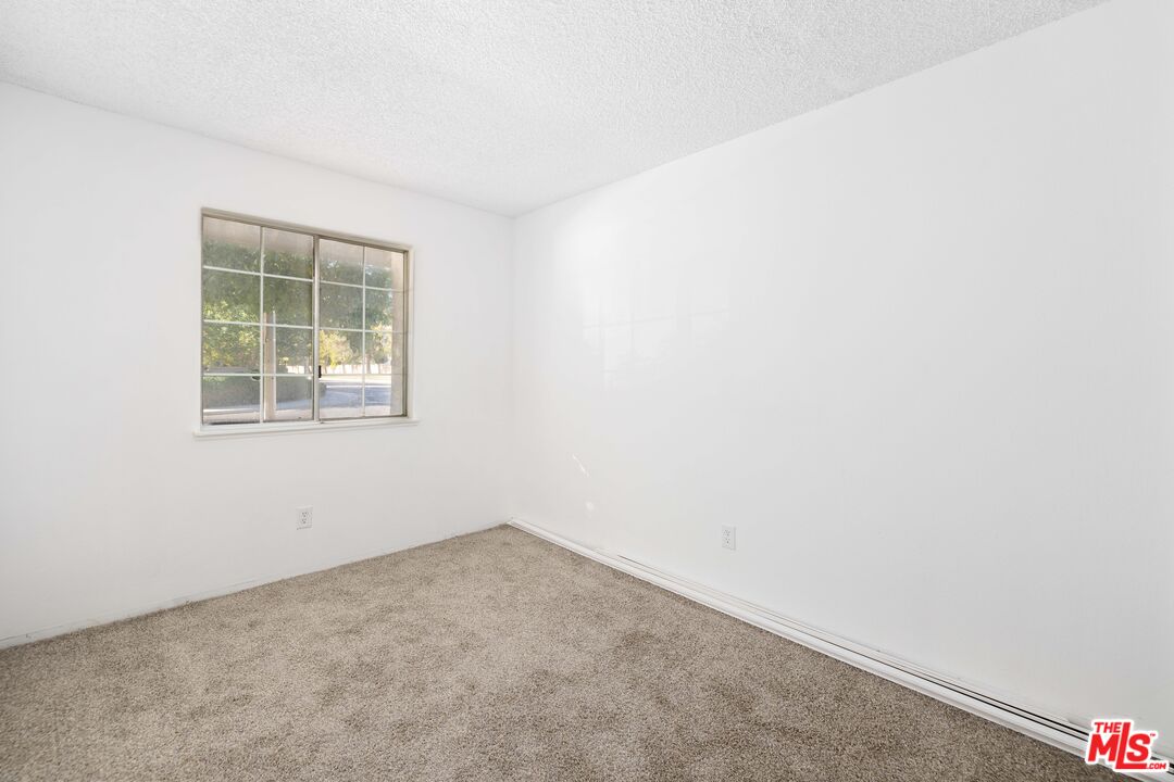 1415 Kings Road Palmdale, CA 93551 - Photo 19 of 27 an empty room with a window