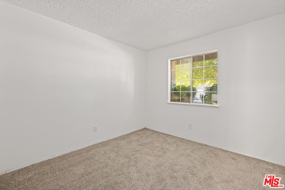 1415 Kings Road Palmdale, CA 93551 - Photo 21 of 27 an empty room with a window