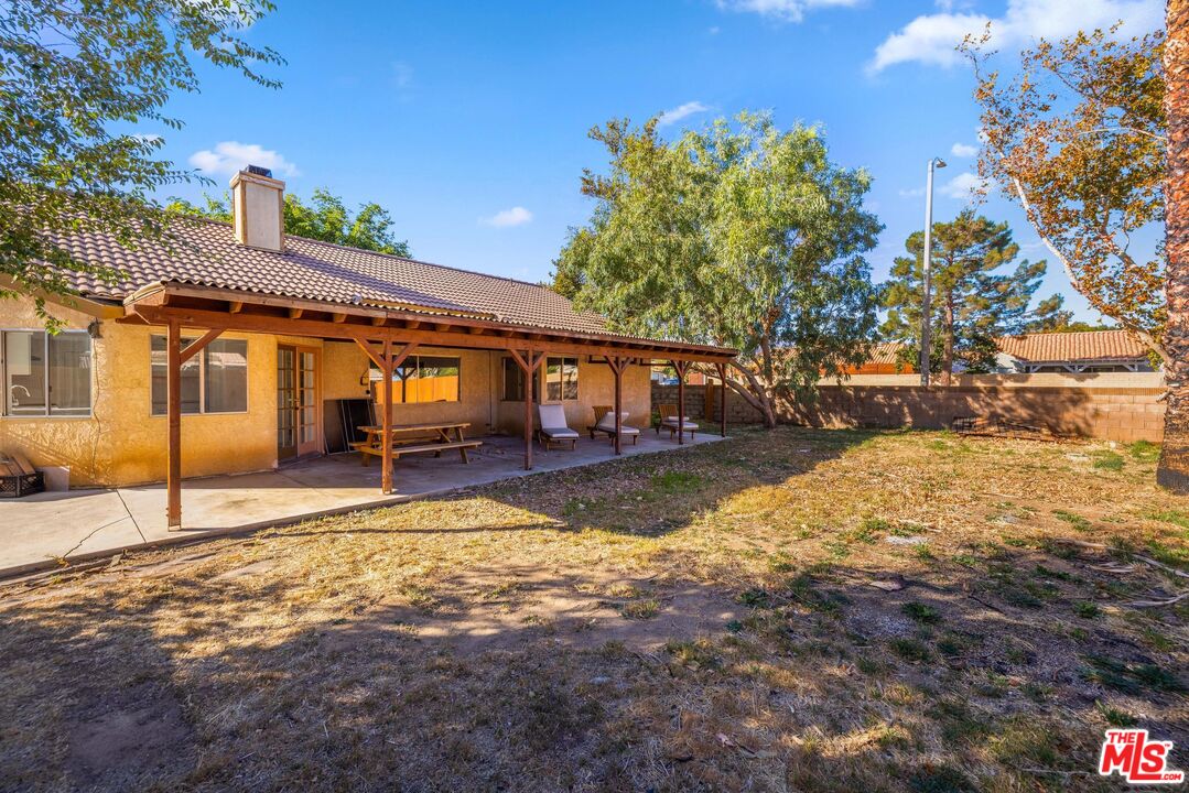 1415 Kings Road Palmdale, CA 93551 - Photo 23 of 27 a view of a house with a yard