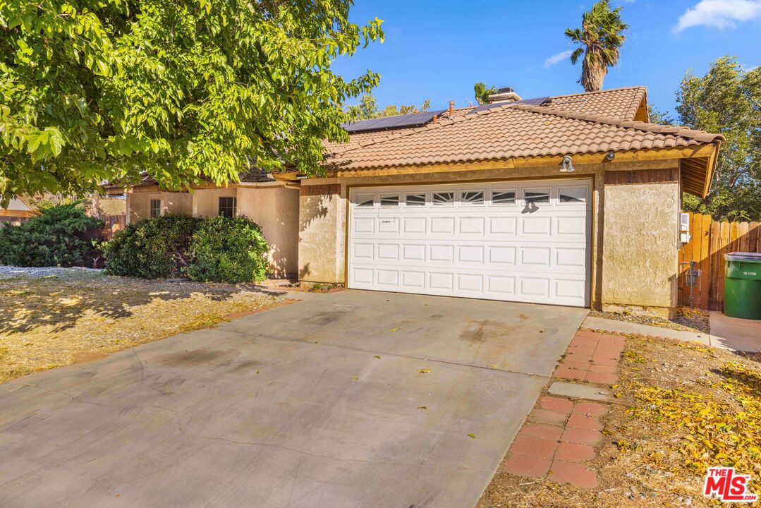 1415 Kings Road Palmdale, CA 93551 - Photo 25 of 27 a front view of a house with a yard